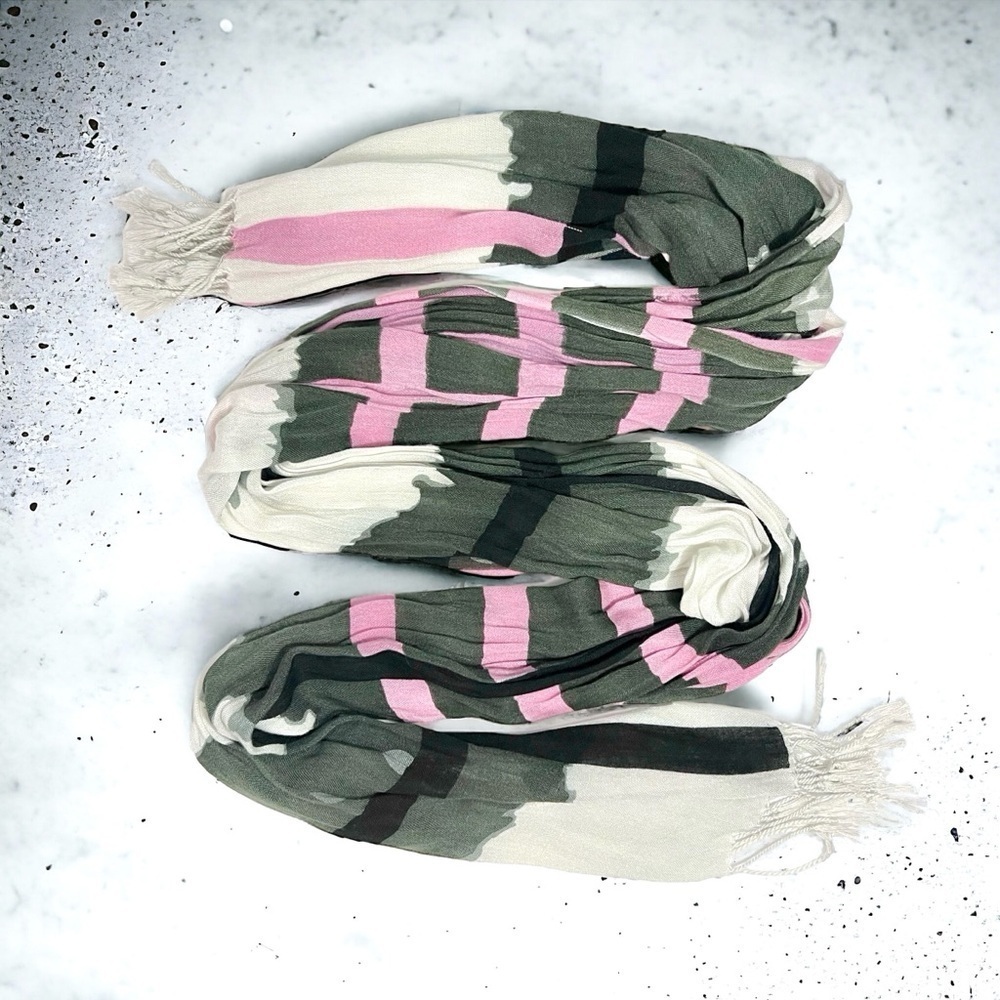 Modern design on this lightweight, pink, black, and white scarf with fringe